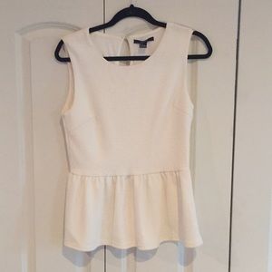 Cream or off-white sleeveless peplum top